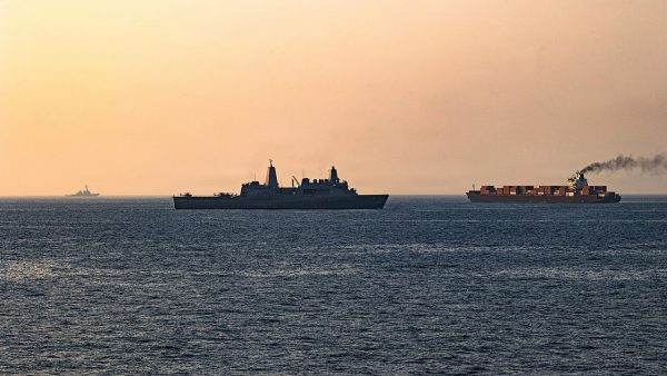 U.S. Navy ships intercept an Iranian vessel, initiating a blockade in the Strait of Hormuz in April 2026.