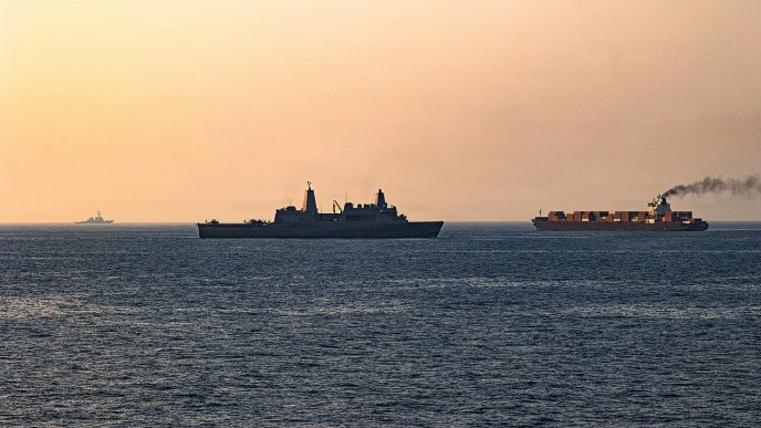 U.S. Navy ships intercept an Iranian vessel, initiating a blockade in the Strait of Hormuz in April 2026.