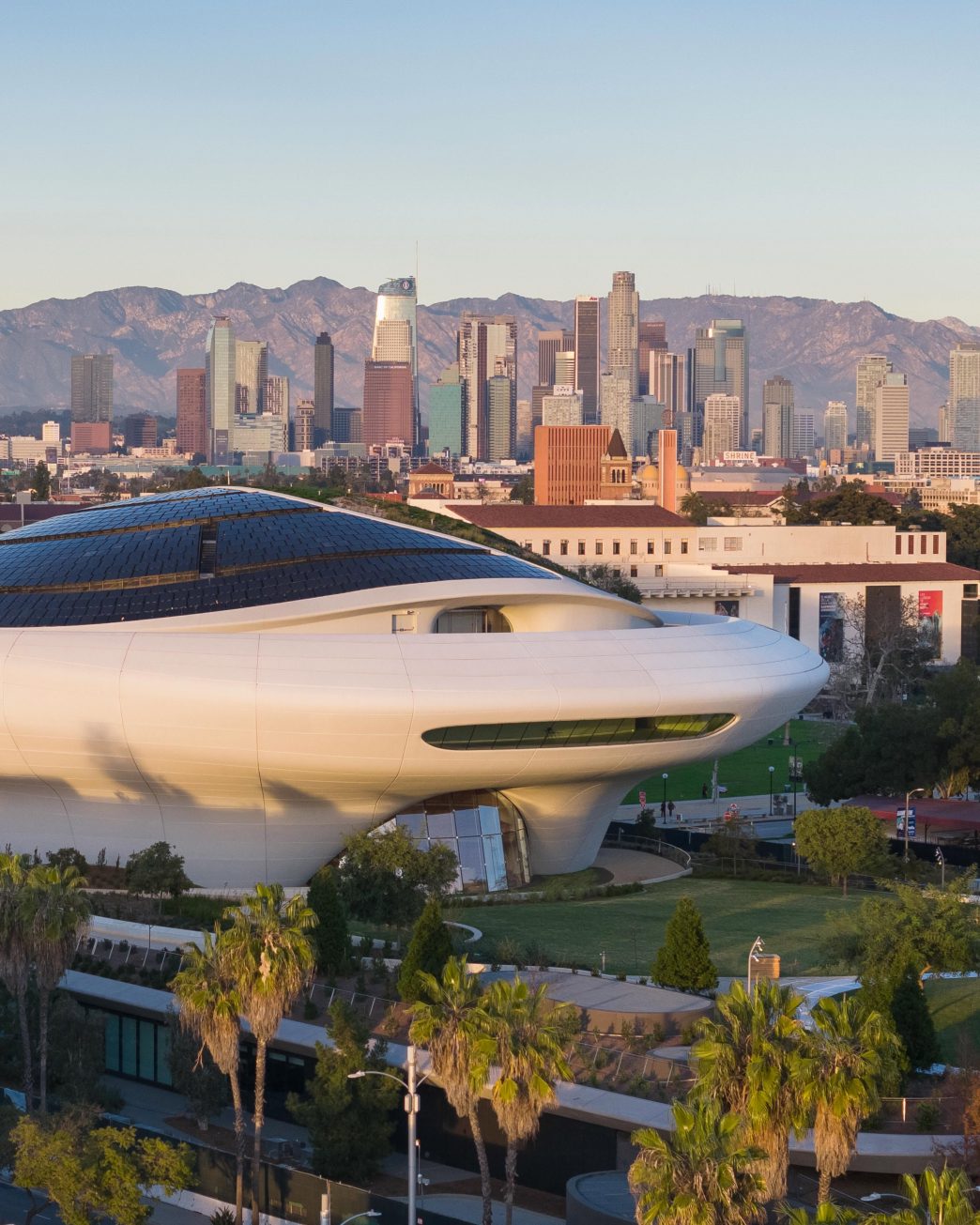 The new Lucas Museum in Exposition Park, with the downtown LA skyline in the background.