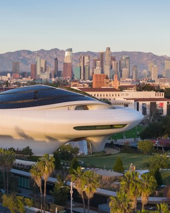 The new Lucas Museum in Exposition Park, with the downtown LA skyline in the background.