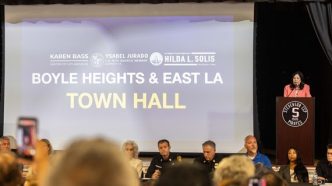Supervisor Hilda Solis, at podium, speaks during a town hall meeting in Boyle Heights following a massive warehouse fire that is still emitting foul-smelling, possibly toxic fumes.