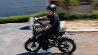 A boy rides an e-bike.