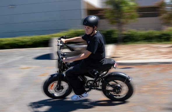 A boy rides an e-bike.