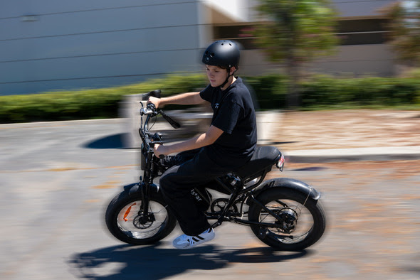 A boy rides an e-bike.