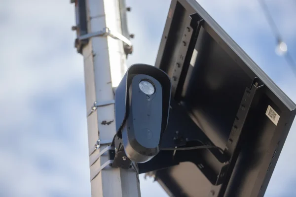 A Flock Safety automatic license plate reader camera is attached to a pole along Olive Avenue in Fresno on Feb. 19, 2026.