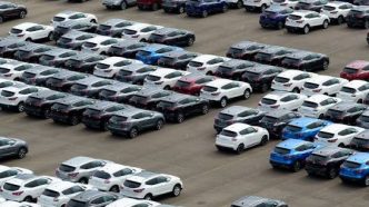 Cars for sale occupy an auto dealership lot.