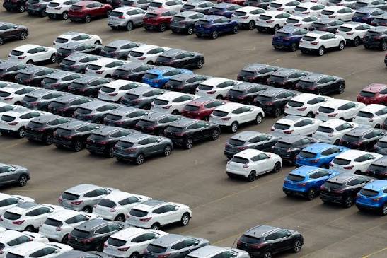 Cars for sale occupy an auto dealership lot.