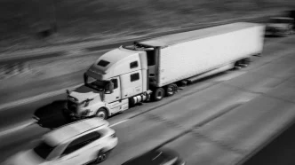 Trucks and cars drive along Interstate 580 through the Altamont Pass.